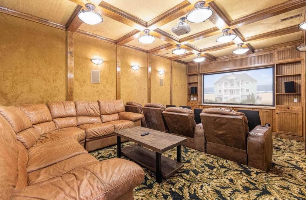 AV installation services for a luxury home theater with projector screen and sectional seating