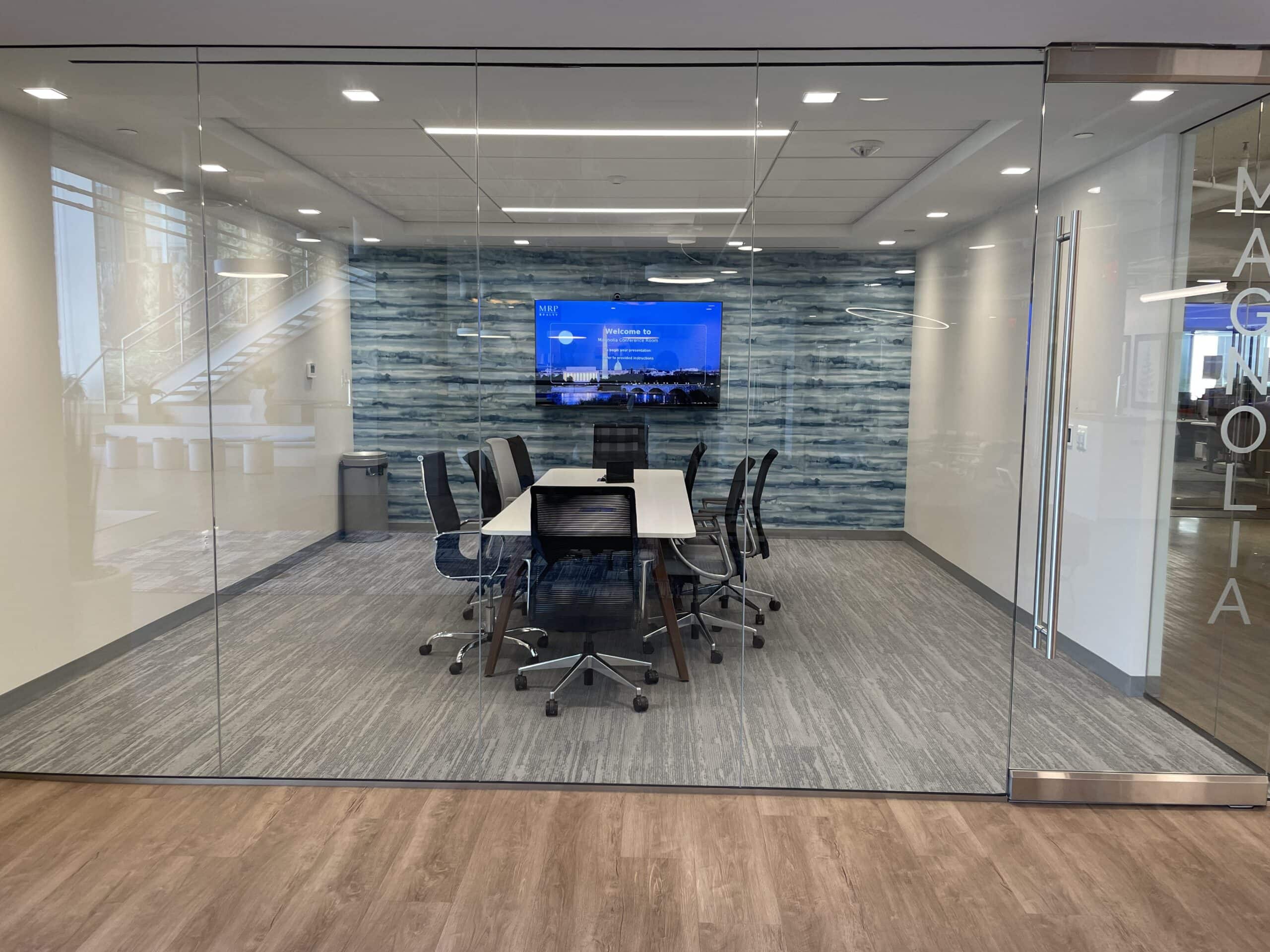 AV installation services for a glass conference room with display and meeting table