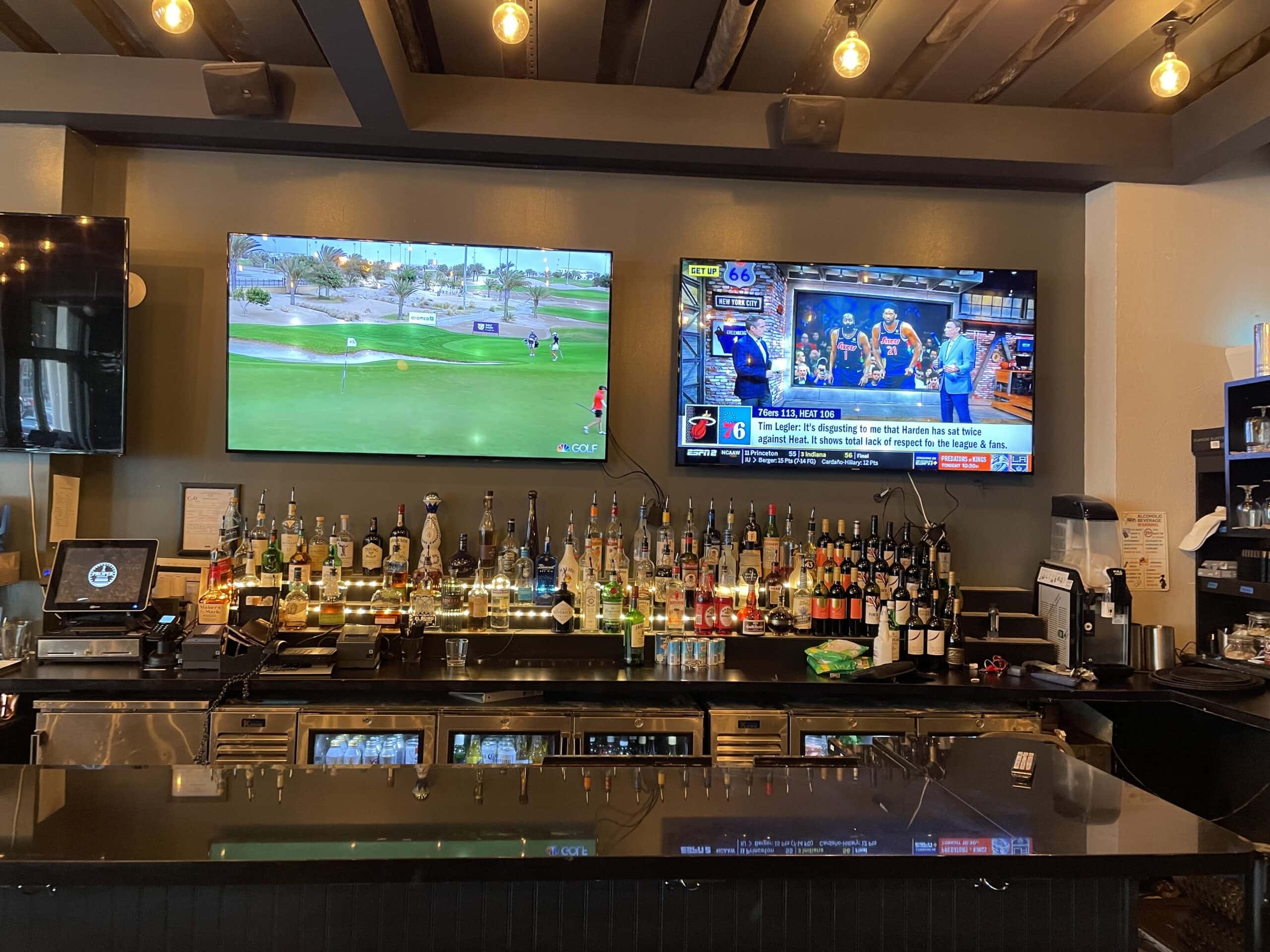 Commercial AV installation with mounted TVs for a bar and entertainment space