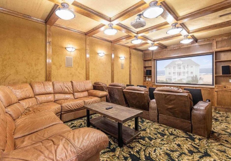 AV installation services for a luxury home theater with projector screen and sectional seating