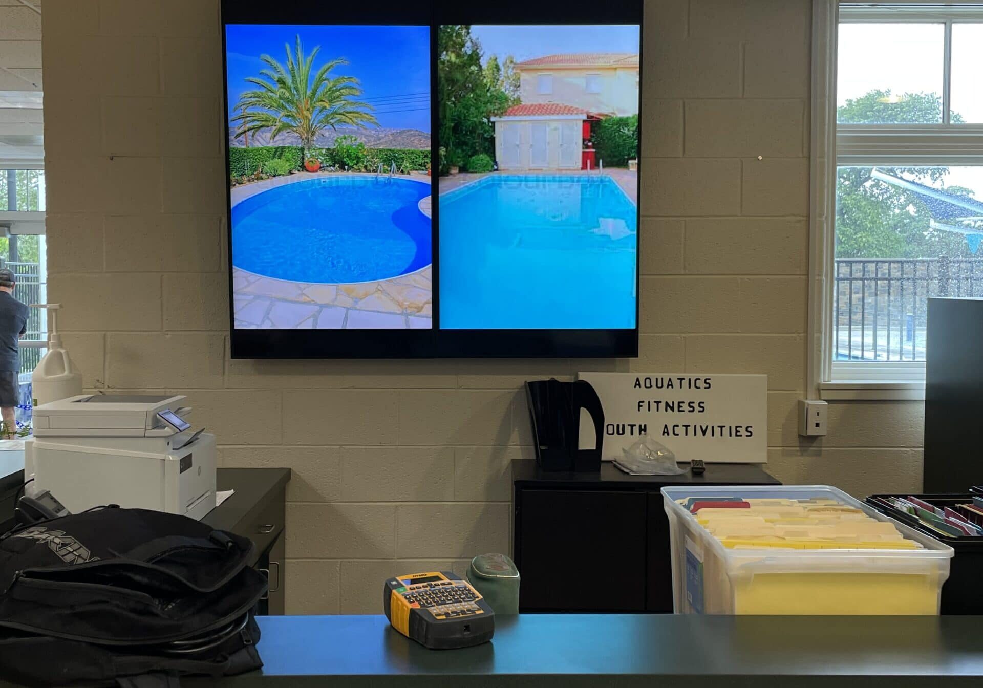 Commercial AV installation with wall-mounted display for a fitness facility