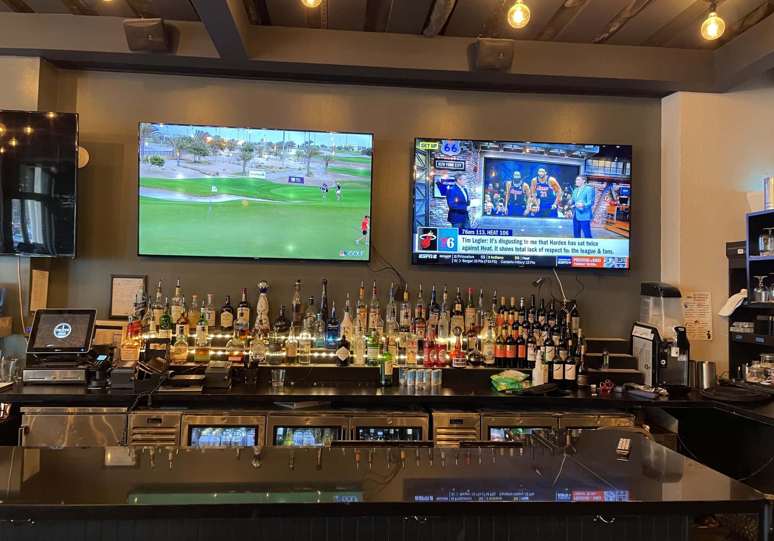 Commercial AV installation with mounted TVs for a bar and entertainment space